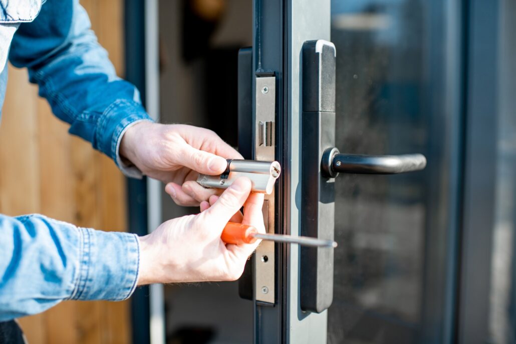 Man changing core of a door lock, Macclesfield Locksmith